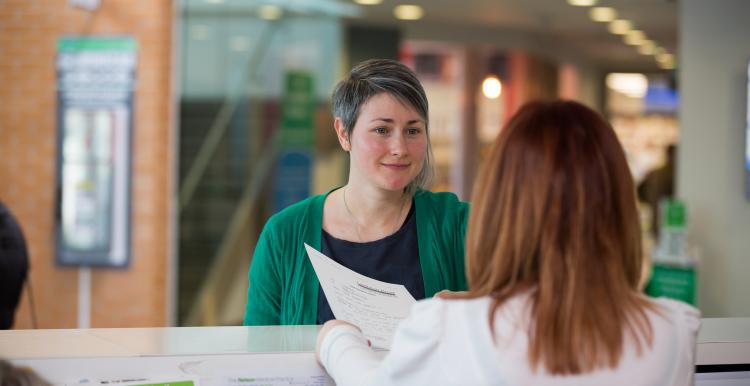 Woman speaking to a receptionist