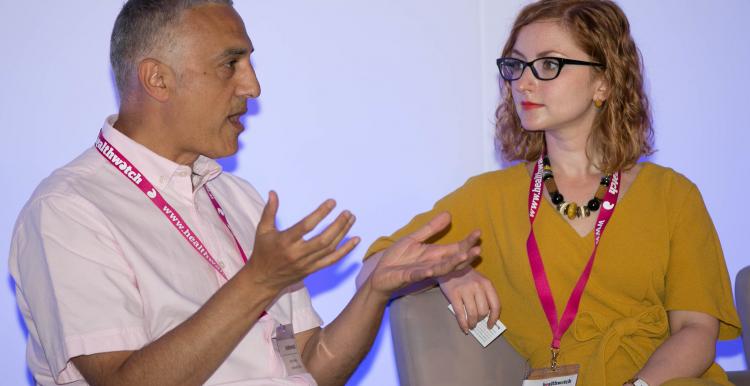 two staff members talking