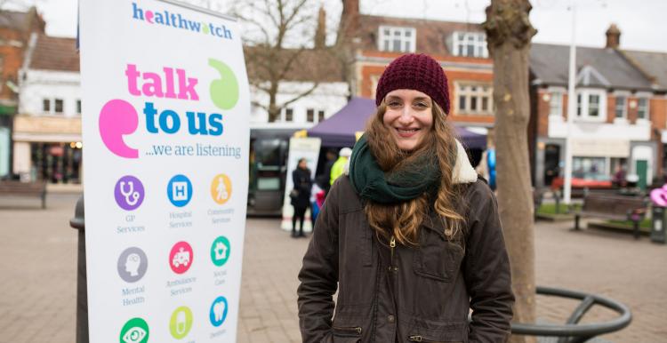 volunteer stood by talk to us banner