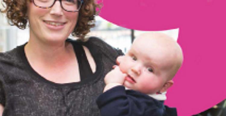 woman and baby infront of speak up banner