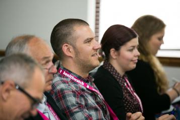 Group of people watching presentation