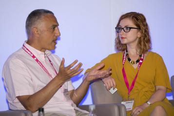 two staff members talking