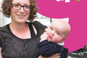 woman and baby infront of speak up banner