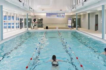 Two people swimming in an indoor pool at Golden Lane